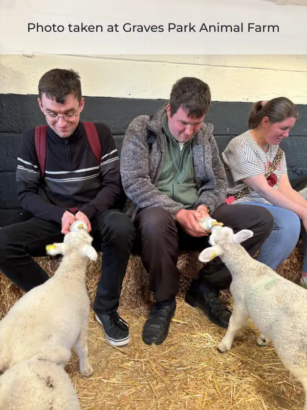 Service users of Fairplay enjoying a day out at Graves Park Animal Farm. feeding baby lambs