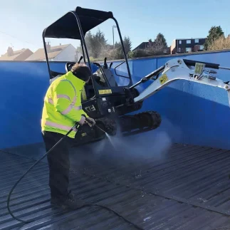 excavator being power washed on a large wash pad pro with water reclaim